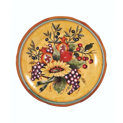 Picture An Italian ceramic plate decorated with a depiction of a sunflower and fruit in a Mediterranean style