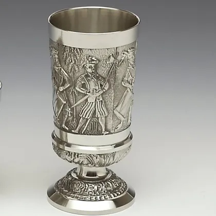 Picture An Irish chalice decorated with a generic medieval scene