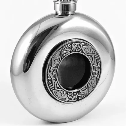 Picture A unique Irish whiskey flask with a glass center decorated with a Celtic pattern
