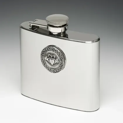 Picture A stylish hip flask with a tin disc decorated with an Irish Claddagh pattern