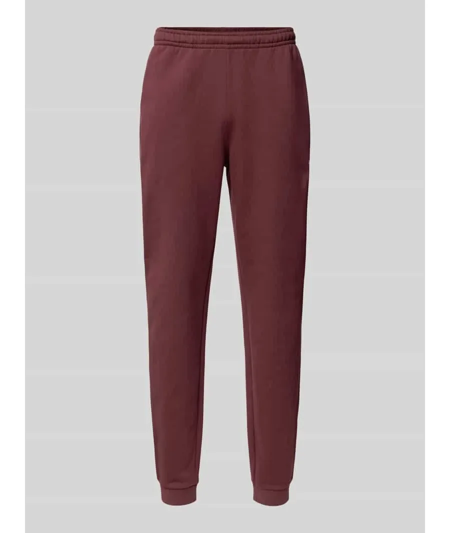 obrazek 1 Spodnie dresowe o kroju tapered fit z nadrukiem z logo model ‘HERITAGE’