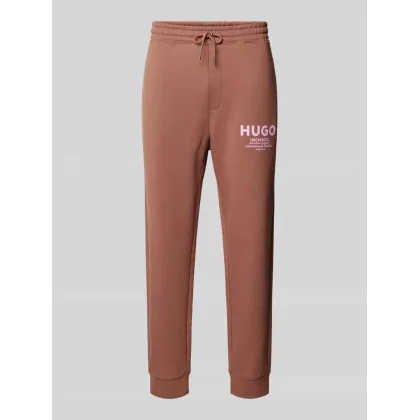 Zdjęcie Spodnie dresowe o kroju tapered fit z nadrukiem z logo model ‘Nevez’