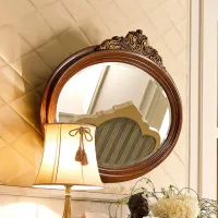 Picture Stylish oval baroque mirror with carved element from Italy