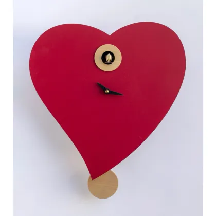 Picture A beautiful clock with a playing cuckoo in the shape of a heart