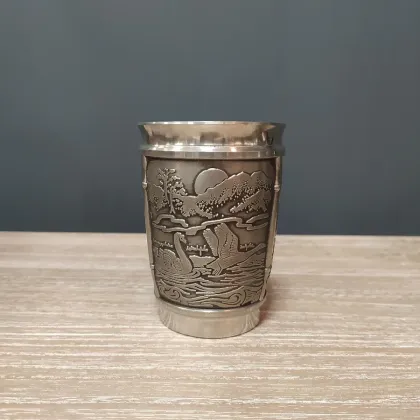 Picture A tin mug with a depiction of the Irish story Children of Lir