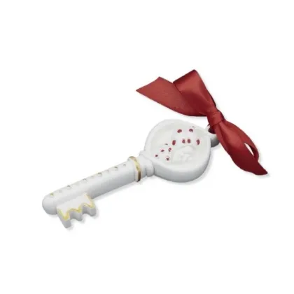 Picture A unique sculpture - a key of fortune with a red ribbon