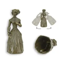 Picture A stylish table bell with a depiction of a lady in a hat, made of bronze