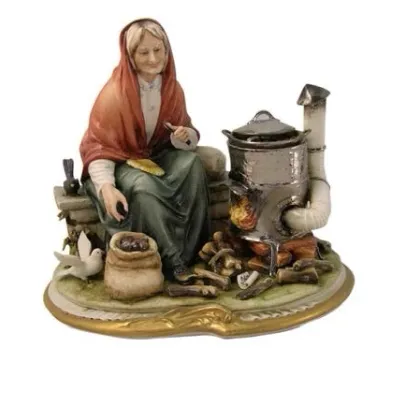 Zdjęcie Porcelanowa figurka kobiety piekącej kasztany