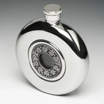 Picture A unique Irish whiskey flask with a glass center decorated with a clover pattern