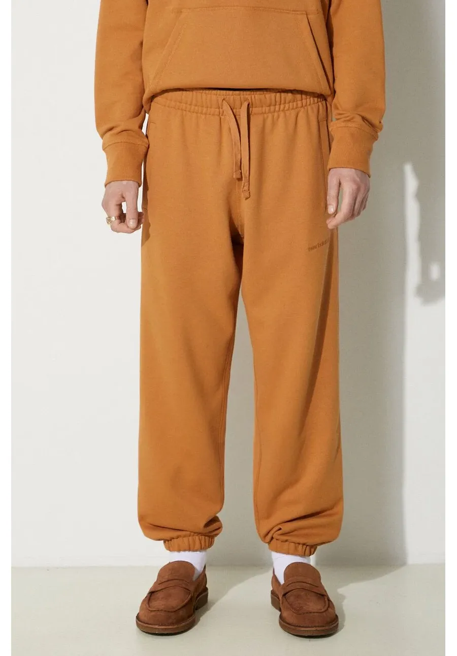 obrazek 1 New Balance spodnie dresowe bawełniane kolor pomarańczowy gładkie (puste)