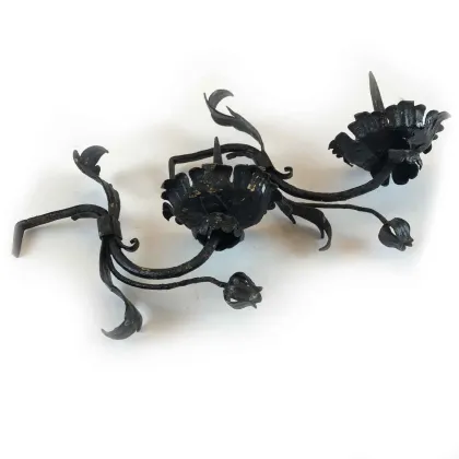 Picture An elegant pair of wrought iron candlesticks from the 17th century
