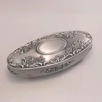 Picture A unique oval jewelry box made of pewter decorated with roses