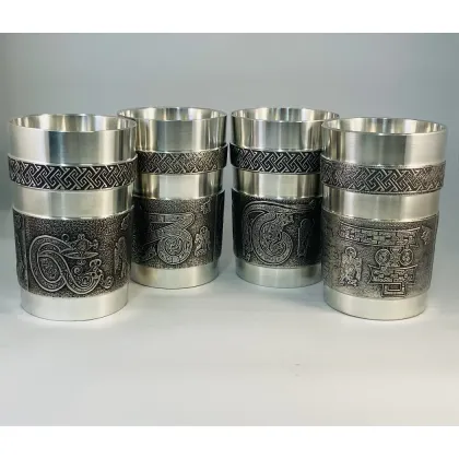 Picture An original set of tin cups with letters from the Book of Kells