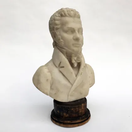 Picture Antique sculpture - bust of a man made of alabaster on a round wooden base