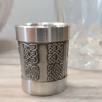 Picture A pewter alcohol measuring cup decorated with Celtic patterns