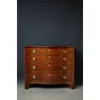 Picture An elegant and solid mahogany chest of drawers in a regency style with a serpentine outline