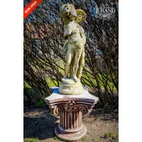 Picture Original sculpture of a boy with an ear of corn