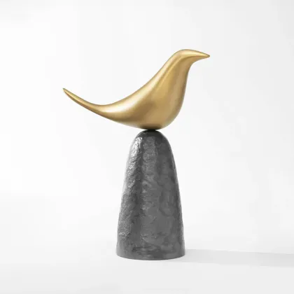 Picture A gold ornament with the likeness of a bird