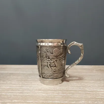 Picture An Irish tin mug depicting the story of the Lira children