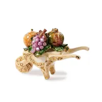 Picture Handmade ceramic figurine of a wheelbarrow with fruit