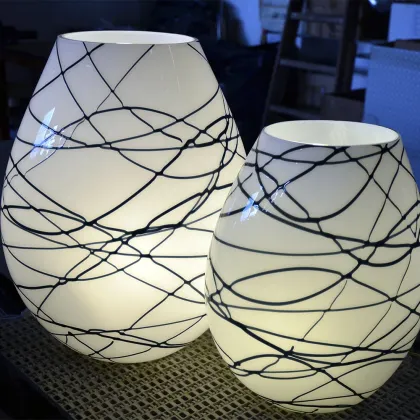 Picture White rounded glass lamp with a variation of black lines