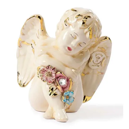 Picture A handmade figurine of an angel with three flowers
