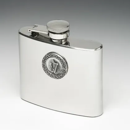 Picture A stylish hip flask with a tin disc decorated with a harp motif