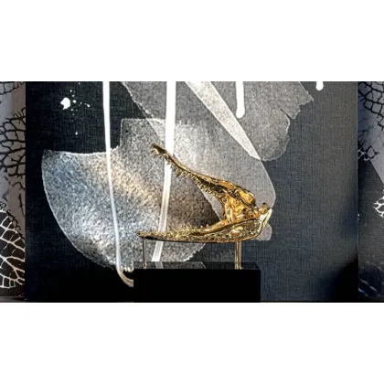 Picture Decorative gilded crocodile on a black wooden base