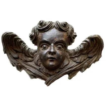 Picture An elegant sculpture of a cherub with wings from the 18th century