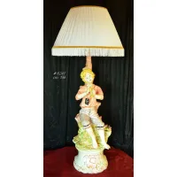 Picture A wonderful decorative lamp with a figurine of a playing boy