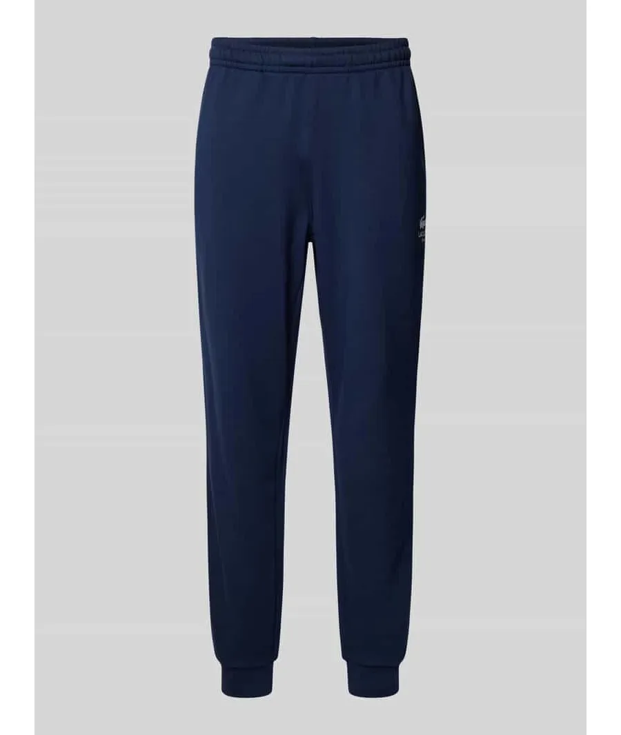 obrazek 1 Spodnie dresowe o kroju tapered fit z nadrukiem z logo model ‘HERITAGE’